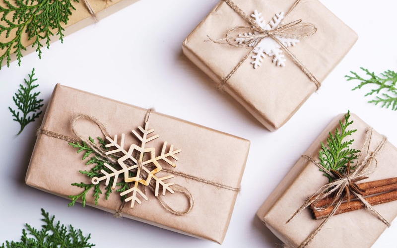Holiday gifts wrapped in brown paper with snowflake decorations